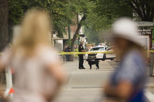 Police and a K-9 unit investigate at Broadway and Hargrave in Winnipeg on Friday, July 3, 2015. Mikaela MacKenzie / Winnipeg Free Press