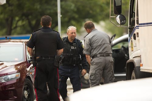 Police and a K-9 unit investigate at Broadway and Hargrave in Winnipeg on Friday, July 3, 2015. Mikaela MacKenzie / Winnipeg Free Press