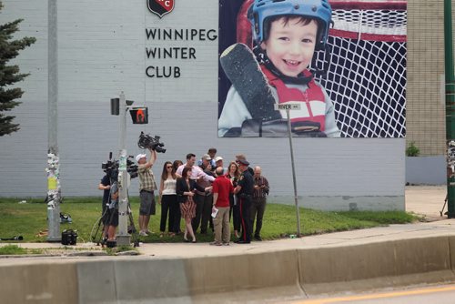 Members of the local media gather together on the corner of Donald at River for a press conference involving a bomb that went off at Petersen and King Law Office at 252 River Ave. Friday morning in the hands of one of the workers in the office.  She was taken to hospital in critical condition.    See story.  July 03,, 2015 Ruth Bonneville / Winnipeg Free Press