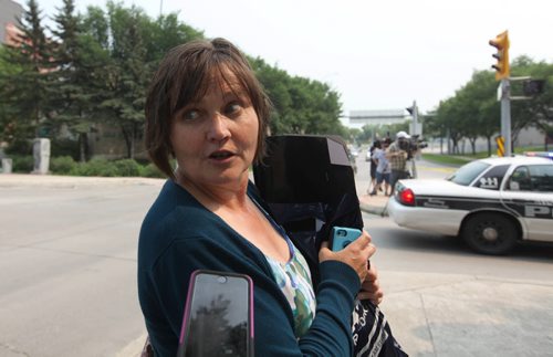 Jeanne Stephenson comments to a reporter about the bomb incident near River Ave. Friday afternoon.  Earlier in the day a bomb went off in the hands of a worker at  Petersen and King Law Office at 252 River Ave.  Streets in area were blocked off for hours.  See story.  July 03,, 2015 Ruth Bonneville / Winnipeg Free Press