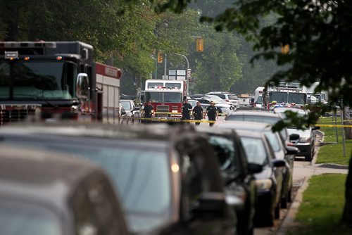 Scene on River Ave. looking east  during investigation of bombing that took place at Petersen and King Law Office at 252 River Ave. Friday morning. A bomb went off in the hands of one of the workers in the office and she was taken to hospital in critical condition.    See story.  July 03,, 2015 Ruth Bonneville / Winnipeg Free Press