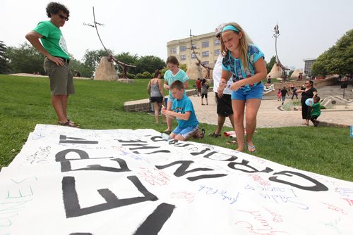 A group of kids make their way to sign a banner stating - Keep it in the ground which was part of a country-wide protest with a local group gathering in the Oodena Circle at the Forks Saturday to raise awareness about saving  the Tar Sands Expansion in Alberta.   See story.   July 04, 2015 Ruth Bonneville / Winnipeg Free Press