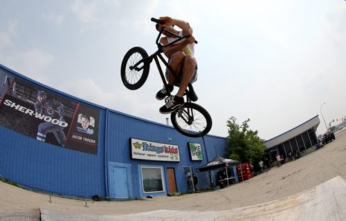 Colin Thiessen does a table top air at the first BMX jam at Royal Sports on Pembina Highway. There was a friendly competition with prizes for tricks, Saturday, July 4, 2015. (TREVOR HAGAN/WINNIPEG FREE PRESS)