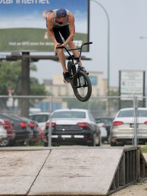 Shawn Franz does a bar spin 360 at the first BMX jam at Royal Sports on Pembina Highway. There was a friendly competition with prizes for tricks, Saturday, July 4, 2015. (TREVOR HAGAN/WINNIPEG FREE PRESS)