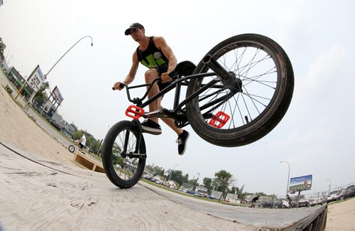 Philippe Bellefeuille, 22, does a double foot jam whip, at the first BMX jam at Royal Sports on Pembina Highway. There was a friendly competition with prizes for tricks, Saturday, July 4, 2015. (TREVOR HAGAN/WINNIPEG FREE PRESS)