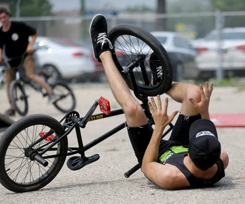 Philippe Bellefeuille takes a little spill at the first BMX jam at Royal Sports on Pembina Highway. There was a friendly competition with prizes for tricks, Saturday, July 4, 2015. (TREVOR HAGAN/WINNIPEG FREE PRESS)