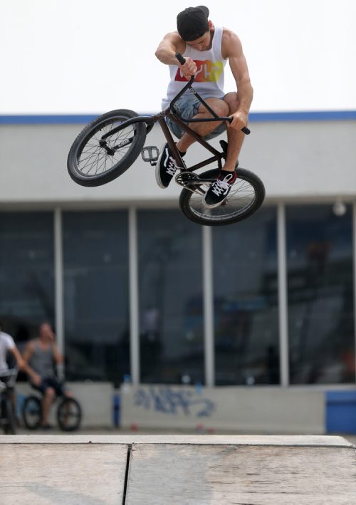 Colin Thiessen does a table top air at the first BMX jam at Royal Sports on Pembina Highway. There was a friendly competition with prizes for tricks, Saturday, July 4, 2015. (TREVOR HAGAN/WINNIPEG FREE PRESS)