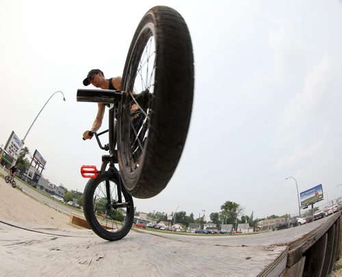 Philippe Bellefeuille, 22, does a double foot jam whip, at the first BMX jam at Royal Sports on Pembina Highway. There was a friendly competition with prizes for tricks, Saturday, July 4, 2015. (TREVOR HAGAN/WINNIPEG FREE PRESS)