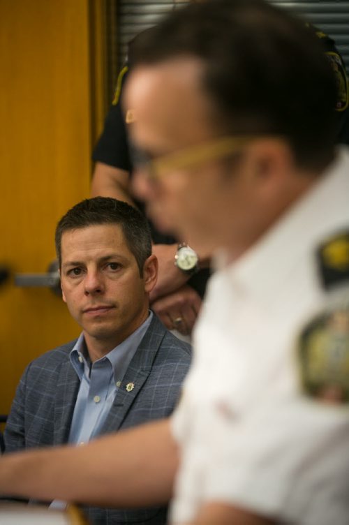 Mayor Bowman listens as Supt. Danny Smyth speaks at Winnipeg Police Service press conference on law firm bombing. Police have charged Guido Amsel two counts of attempted murder in relation to the bomb that detonated at a law firm injuring lawyer Maria Mitousis. Police have the city on high alert, as there may be additional packages.   July 06, 2015 - MELISSA TAIT / WINNIPEG FREE PRESS