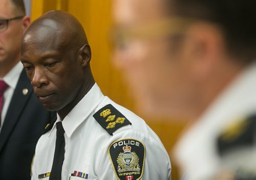 Winnipeg Police Chief Devon Clunis listens as Supt. Danny Smyth speaks at Winnipeg Police Service press conference on law firm bombing. Police have charged Guido Amsel two counts of attempted murder in relation to the bomb that detonated at a law firm injuring lawyer Maria Mitousis. Police have the city on high alert, as there may be additional packages.   July 06, 2015 - MELISSA TAIT / WINNIPEG FREE PRESS