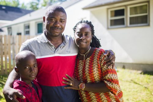 Othello Wesee (centre) and his wife and son, Vivian and Othello, sit in their living room together in Winnipeg on Tuesday, July 7, 2015.  Othello had been fighting for seven years to get his wife and son visas to be able to join him in Canada after living in a refugee camp in Ghana, and the family was finally reunited last Saturday. Mikaela MacKenzie / Winnipeg Free Press