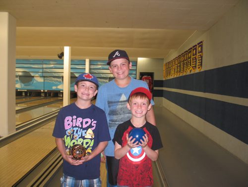 Canstar Community News July 2, 2015 - Aiden, Cole and Logan Newton enjoy bowling at Rossmere Lanes (1042 Henderson Hwy.)