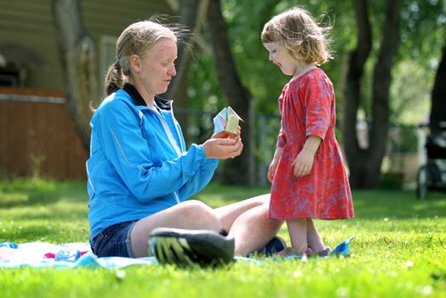 Two and a half-year-old, Eloise Lamont shows her excitement as she plays - Snap Dragon, a origami paper game also known as, paper fortune teller, with her mom, Aileen, Tuesday afternoon under sunny skies on a blanket in Cordova Park.  July 07, 2015 Ruth Bonneville / Winnipeg Free Press