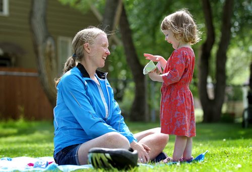 Two and a half-year-old, Eloise Lamont shows her excitement as she plays - Snap Dragon, a origami paper game also known as, paper fortune teller, with her mom, Aileen, Tuesday afternoon under sunny skies on a blanket in Cordova Park.  July 07, 2015 Ruth Bonneville / Winnipeg Free Press