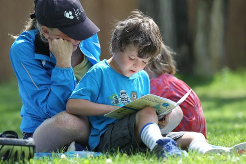 Seven-year-old Ronan Lamont learns to read a book, he picked at the library earlier in the day to his mom, Aileen, while his little sister, Eloise, plays beside him at while at Cordova Park Tuesday afternoon.    July 07, 2015 Ruth Bonneville / Winnipeg Free Press