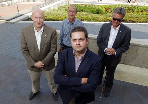 Five councillors are rallying against the citys cycling strategy and took out a radio ad today that will run until council votes on the strategy next Wednesday. Four of those councillors: Jason Schreyer, Shawn Dobson, and Ross Eadie stand behind Jeff Browaty(centre) in this photo. BORIS MINKEVICH/WINNIPEG FREE PRESS July 8, 2015