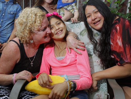 Middle, Allexis Siebrecht is the 11-year-old liver transplant girl who got back to Winnipeg early Tuesday morning. The family held a press conference at their home in Windsor Park. Left, family friend Tina Lussier, left, who acted as a spokeswoman to media, and right Allexis' mum Liz. Aidan Geary story. BORIS MINKEVICH/WINNIPEG FREE PRESS July 8, 2015