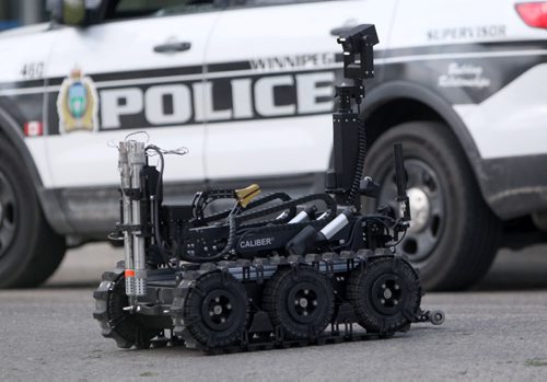 Winnipeg Police used their bomb unit robot to shoot a water canon at a suspicious package found at St Annes and Bank Ave- Robot heads back to bomb unit once fished-Breaking News- July 08, 2015   (JOE BRYKSA / WINNIPEG FREE PRESS)