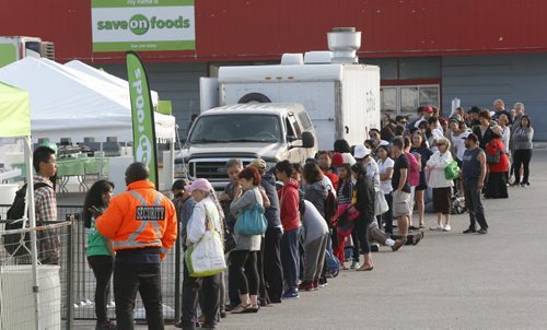 A long line was formed early Thursday morning for the Save On Foods supermarket event that included a pancake breakfast and live entertainment on the parking lot of the Northgate Shopping Centre on McPhillips St. The first 300 of the 800 in line also receive a bag of nonperishable food items.  Later in the morning Vancouver-based Save On Foods supermarket chain unveiled its expansion plans for the Manitoba market including taking over the former Zellers store at this location.  Wayne Glowacki / Winnipeg Free Press July 9  2015
