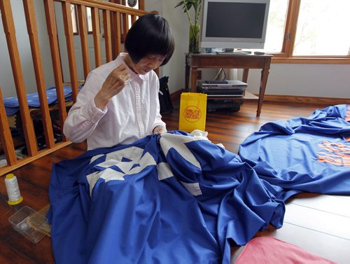 Ruirong Auntie Chen, 70, photographed at her friends house making a banner for upcoming rally to mark the anniversary of the persecution of Falun Gong. BORIS MINKEVICH/WINNIPEG FREE PRESS July 9, 2015