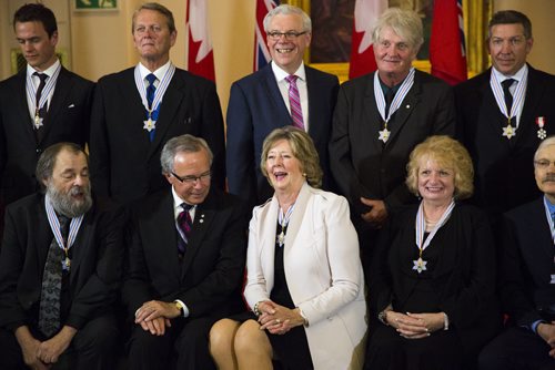 Janice Filmon, Liuetenant governor of Manitoba, laughs in a group photo with recipients of the Order of Manitoba at the Manitoba Legislative Building in Winnipeg on Thursday, July 9, 2015.   Mikaela MacKenzie / Winnipeg Free Press