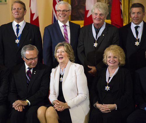 Janice Filmon, Liuetenant governor of Manitoba, laughs in a group photo with recipients of the Order of Manitoba at the Manitoba Legislative Building in Winnipeg on Thursday, July 9, 2015.   Mikaela MacKenzie / Winnipeg Free Press