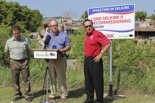 Conservation Minister Tom Nevakshonoff, Finance Minister Gary Dewar, and Selkirk Mayor Larry Johannson announced demolition and clean-up of the MS Lord Selkirk, in the background. BILL REDEKOP / Winnipeg Free Press july 10, 2015