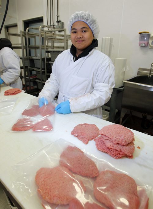 Marie Quintos works as a meat packaging specialist in To-Le-Dos main production plant. Its for a story on the need for more meat cutters and the ongoing challenge of attracting young people to the trade. BORIS MINKEVICH/WINNIPEG FREE PRESS July 8, 2015
