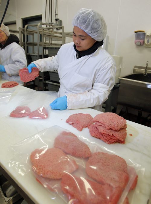 Marie Quintos works as a meat packaging specialist in To-Le-Dos main production plant. Its for a story on the need for more meat cutters and the ongoing challenge of attracting young people to the trade. BORIS MINKEVICH/WINNIPEG FREE PRESS July 8, 2015