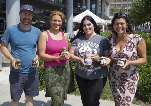 Unique products, baking and produce are available at the outdoor Downtown Farmers Market at Manitoba Hydro Place. The market, organized by Downtown Winnipeg BIZ, is open from 10 a.m. to 3 p.m. every Thursday during the summer months, until mid-September. It then reverts to a monthly event indoors. Pictured, from left, are Chris Kirouac (beeproject.ca), Rebecca Hadfield (zenbars.ca), Angela Filbert (whippedcosmetics.com) and Bessie Hatizitrifonos (bessiesbestfoods.com). (John Johnston / Winnipeg Free Press)