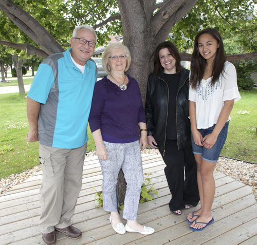 The 10th annual Latter-day Saints Summer Food Drive kicks off Saturday, June 18, 2015. Volunteers will be dropping off a flyer listing Winnipeg Harvests 10 most-needed items during the lean summer months. Pictured, from left, are Jeff Hadfield, Maggie Hadfield, Charlene Laluk (special events co-ordinator, Church of Latter-day Saints) and Victoria DeGuzman. (John Johnston / Winnipeg Free Press)