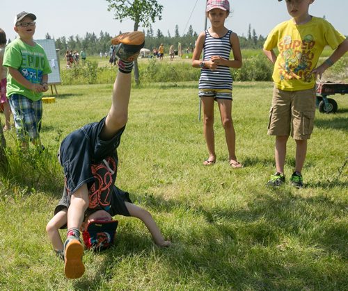Thomas does a somersault at the Winnipeg Folk Festival Friday afternoon. Winnipeg Folk Fest 2015 kids - see Jen Zoratti column. July 10, 2015 - MELISSA TAIT / WINNIPEG FREE PRESS