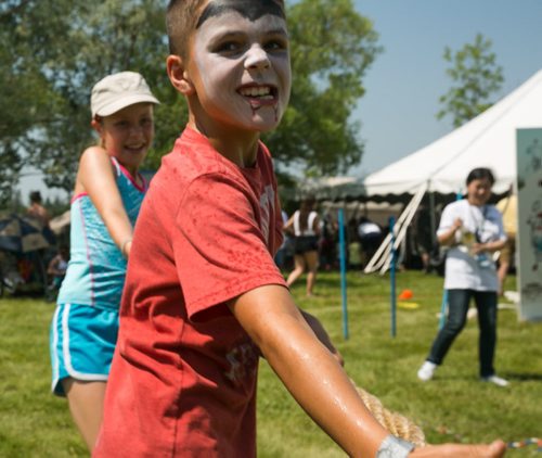 Henry Johnson, 8, plays tug-of-war at the Winnipeg Folk Festival Friday afternoon. Winnipeg Folk Fest 2015 kids - see Jen Zoratti column July 10, 2015 - MELISSA TAIT / WINNIPEG FREE PRESS