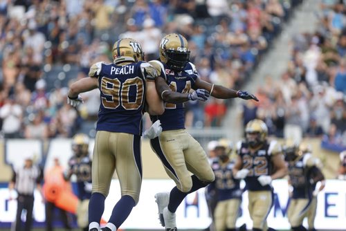Winnipeg Blue Bombers #90 Greg Peach and #14 Lin-J Shell celebrate the second touchdown of the game just seconds before halftime at the Stadium Friday.   July 10, 2015 Ruth Bonneville / Winnipeg Free Press