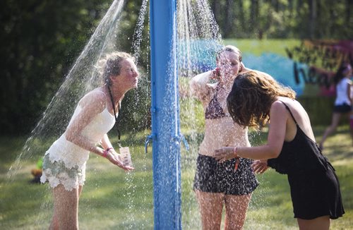 People cool off at the showers at the Winnipeg Folk Festival in Birds Hill Park on Friday, July 10, 2015.   Mikaela MacKenzie / Winnipeg Free Press