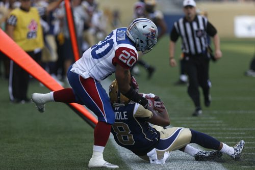 Winnipeg Blue Bomber #8 Chris Randle intercepts the ball from Montreal Alouettes #20 Tyrell Sutton during the first few minutes of the game at the Stadium Saturday.  July 10, 2015 Ruth Bonneville / Winnipeg Free Press