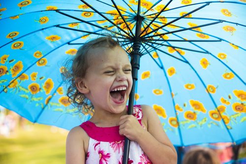 Bell Moravcik, 3, is thrilled with her parasol at the Winnipeg Folk Festival in Birds Hill Park on Friday, July 10, 2015.   Mikaela MacKenzie / Winnipeg Free Press