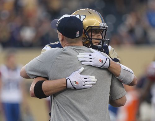 Winnipeg Blue Bomber  QB Drew Willy gets a hug from coach Mike OShea after defeating the  Montreal Alouettes 25-23 -See Paul Wiecek story- July 10, 2015   (JOE BRYKSA / WINNIPEG FREE PRESS)