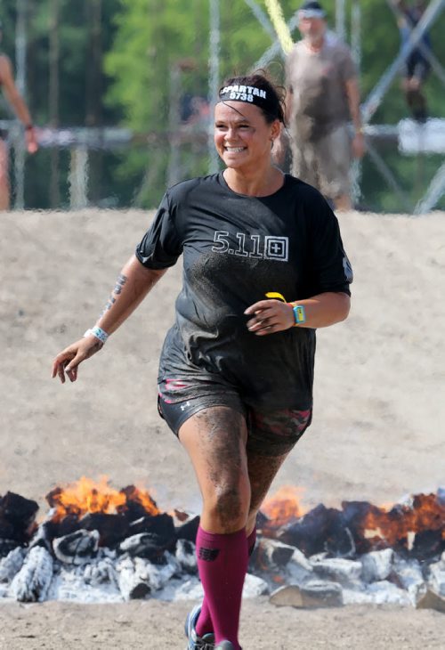 Along with her father, 68 year old, Leonard, not shown, Gina Dolezsar completes the Spartan Race, a 5km obstacle course in Grunthal, Saturday, July 11, 2015. (TREVOR HAGAN/WINNIPEG FREE PRESS)