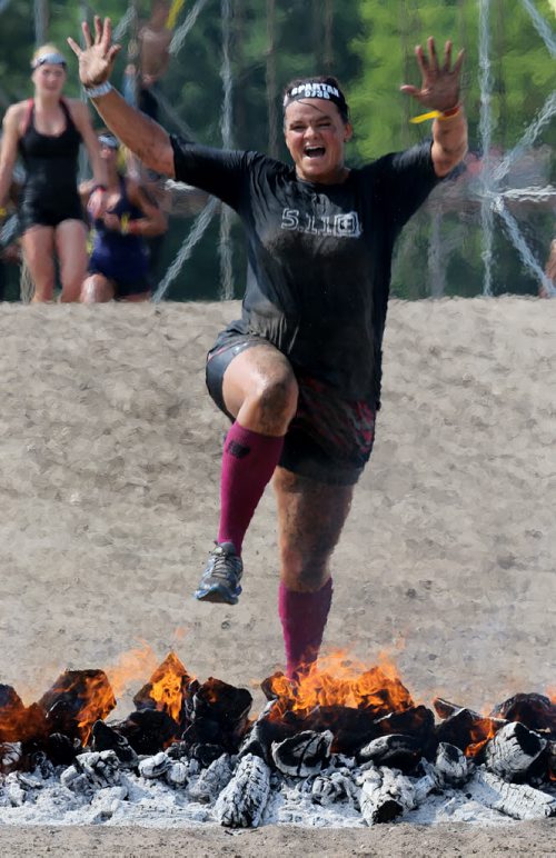 Along with her father, 68 year old, Leonard, not shown, Gina Dolezsar completes the Spartan Race, a 5km obstacle course in Grunthal, Saturday, July 11, 2015. (TREVOR HAGAN/WINNIPEG FREE PRESS)
