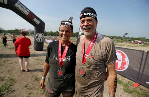Gina Dolezsar with her father, 68 year old, Leonard, after completing the Spartan Race, a 5km obstacle course in Grunthal, Saturday, July 11, 2015. (TREVOR HAGAN/WINNIPEG FREE PRESS)