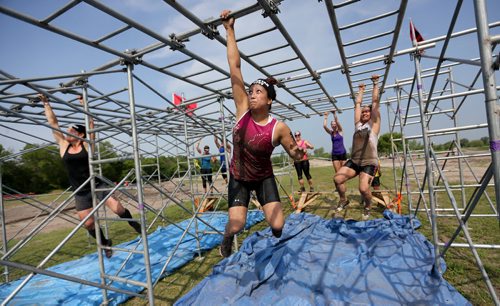 Carolynn San Diego completes an obstacle at the Spartan Race, a 5km obstacle course in Grunthal, Saturday, July 11, 2015. (TREVOR HAGAN/WINNIPEG FREE PRESS)