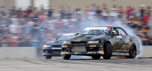 Brad Carlton, left, from Mississauga, and Mats Baribeau, from Brockville, Ontario, drifting during a Formula D Canada drifting demo at the Red River Ex Grounds during Driven, a car show, Saturday, July 11, 2015. (TREVOR HAGAN/WINNIPEG FREE PRESS)