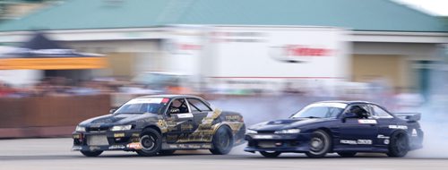 Mats Baribeau, left, from Brockville, Ontario, and Brad Carlton, from Mississauga, drifting during a Formula D Canada drifting demo at the Red River Ex Grounds during Driven, a car show, Saturday, July 11, 2015. (TREVOR HAGAN/WINNIPEG FREE PRESS)