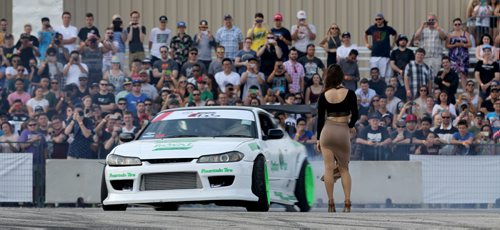 Chris Gonzalez, from Winnipeg, drifting circles around a woman, during a Formula D Canada drifting demo at the Red River Ex Grounds during Driven, a car show, Saturday, July 11, 2015. (TREVOR HAGAN/WINNIPEG FREE PRESS)