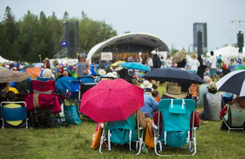 People enjoy the Winnipeg Folk Festival despite the brief spot of rain at Birds Hill Provincial Park on Saturday, July 11, 2015.   Mikaela MacKenzie / Winnipeg Free Press