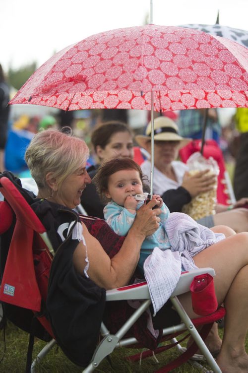 Iris Hrabi plays with her granddaughter, Thea Hanson, under an umbrella at the Winnipeg Folk Festival at Birds Hill Provincial Park on Saturday, July 11, 2015.   Mikaela MacKenzie / Winnipeg Free Press