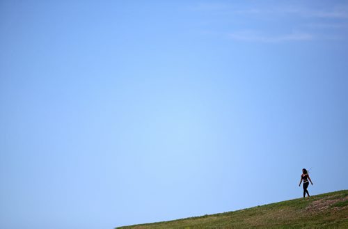 A woman enjoys the sun a hill in Civic Park, Sunday, July 12, 2015. (TREVOR HAGAN/WINNIPEG FREE PRESS)