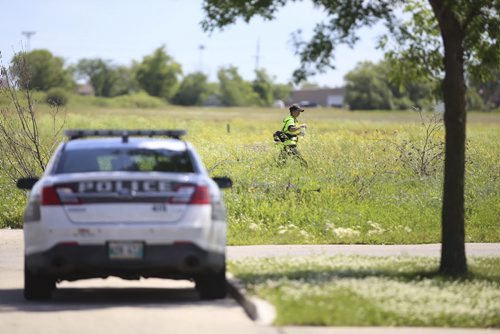 A member of the Winnipeg Search and Rescue (SAR) is seen walking through a field before the search for missing WInnipeg resident Thelma Krull gets underway. Sunday, July 12, 2015. (TREVOR HAGAN / WINNIPEG FREE PRESS)