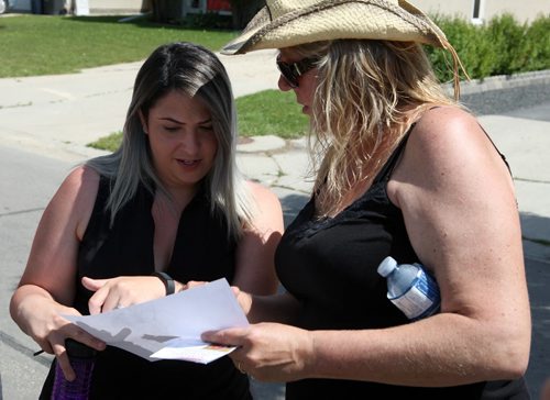 Left, Connie Muscat, friend and coworker assisting in the search for Thelma Krull talks to Susan Dell as they get regrouped. BORIS MINKEVICH/WINNIPEG FREE PRESS July 13, 2015